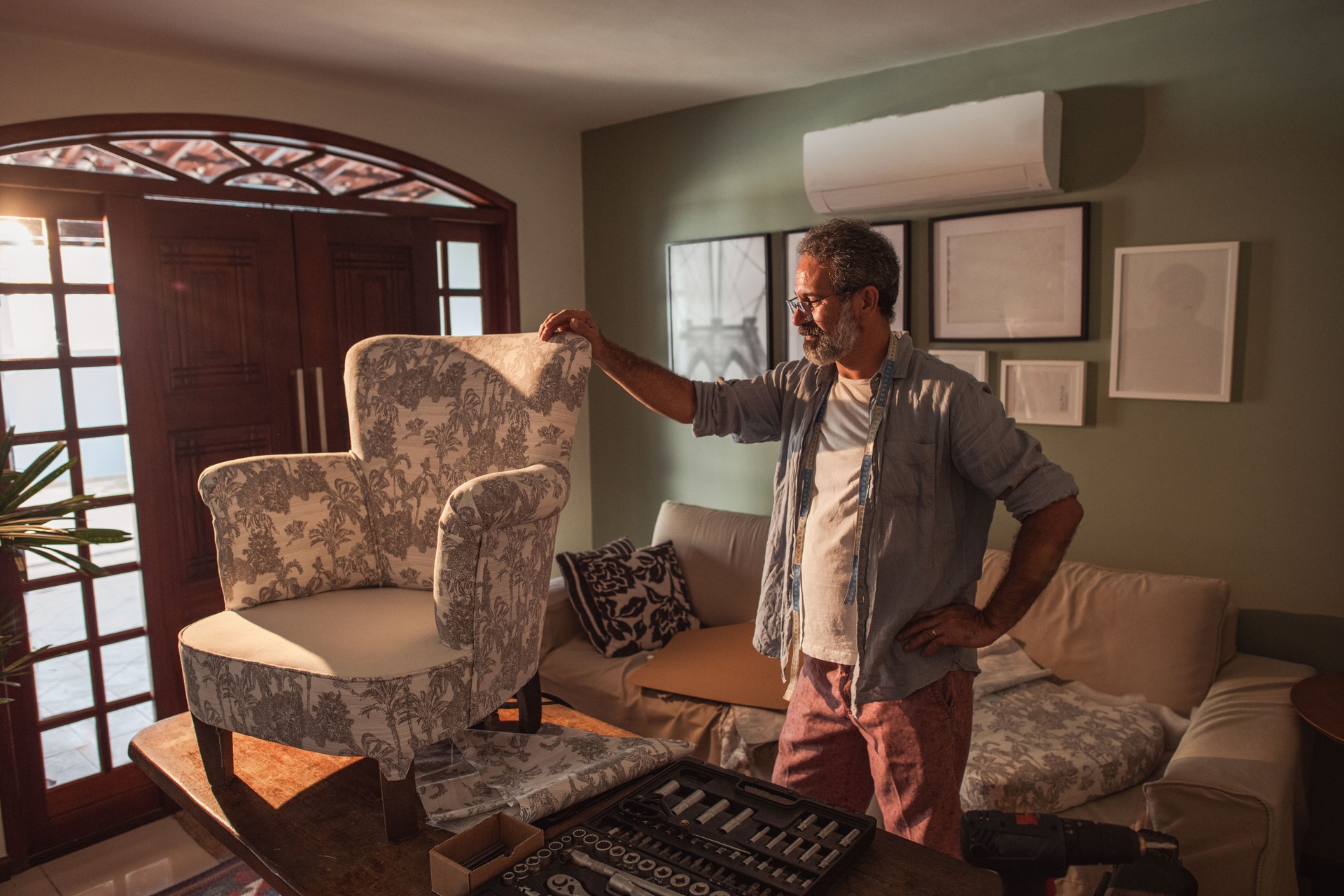 A proud upholsterer looking at this work of art.